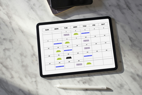 Tablet laying on table showing calendar for April with content pillars on days as part of an Instagram Strategy